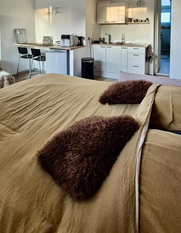 a bed with two furry pillows on top of it at Studio Margny in Margny