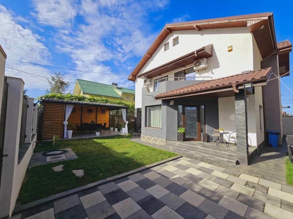 a house with a patio and a yard at Casa Erty in Eforie Nord