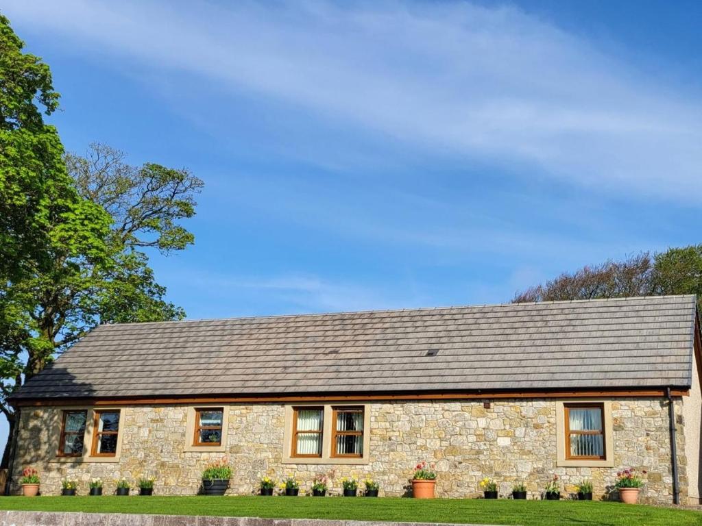 a stone house with a gray roof at 3 Bed in Bathgate oc-90491 in Fauldhouse