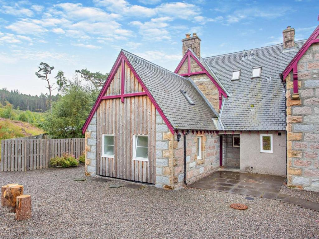 a barn style house with a stone building at 1 Bed in Ardross oc-95533 in Alness