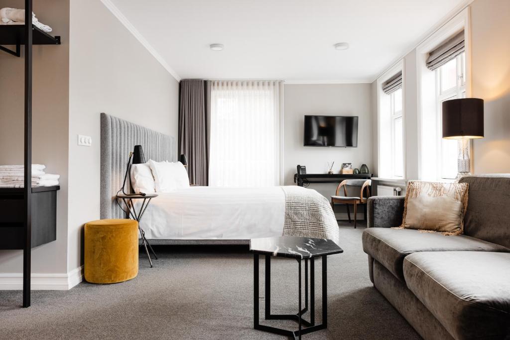 a hotel room with a bed and a couch at Reykjavik Residence Apartment Hotel in Reykjavík