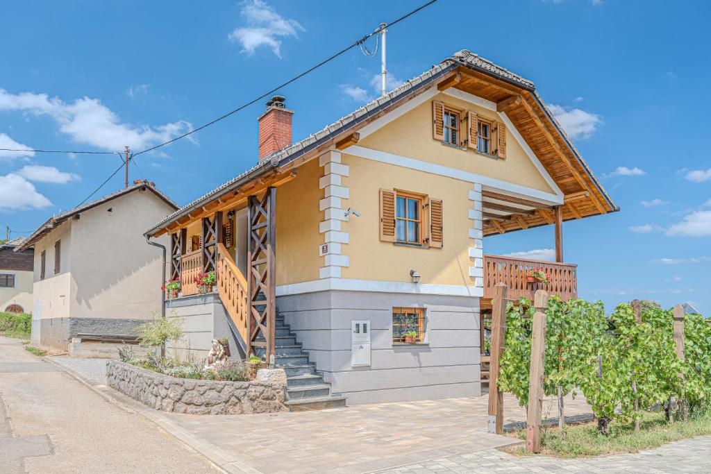 a large house with a gambrel roof at Vineyard Cottage Stepan in Črnomelj