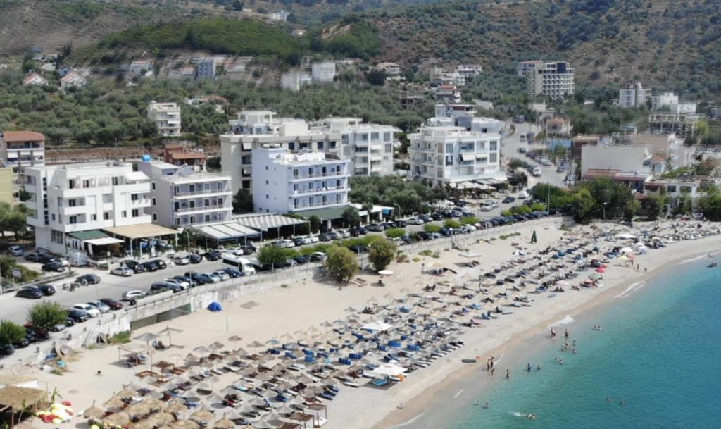 an aerial view of a beach with umbrellas at Hotel Prinos in Himare