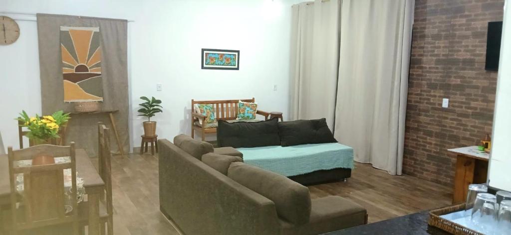 a living room with a couch and a bed in it at Espaço MV Family in Prado