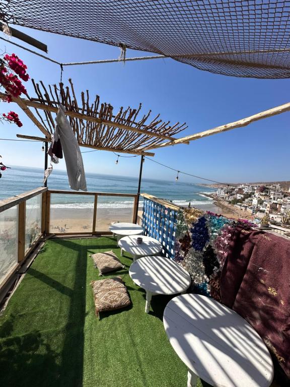 a balcony with chairs and a view of the beach at The Trizit in Taghazout