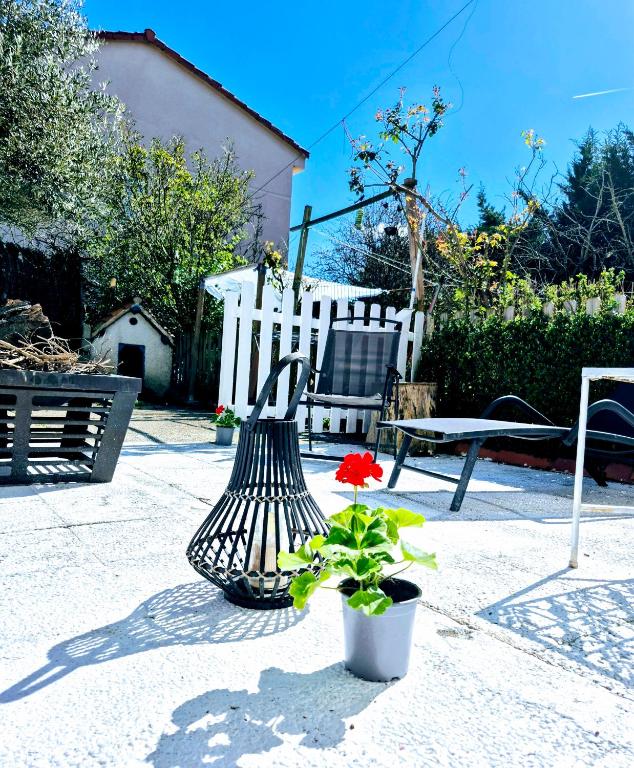 a plant in a pot next to a white fence and a chair at Bed in mixed room of 3 to 4 or private room for 3 to 4 in Zizur Mayor