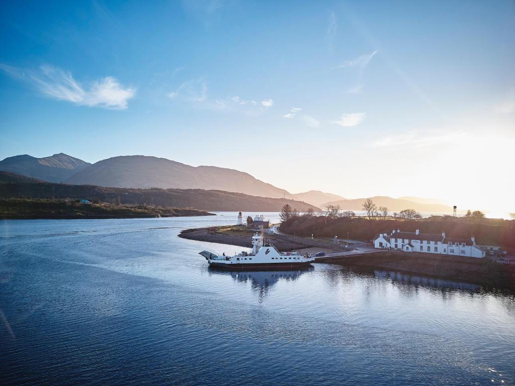 a boat is docked in the water on a river at Inn at Ardgour in Onich