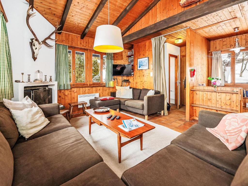 a living room with a couch and a table at Chalet Sven Heul by Interhome in Nendaz