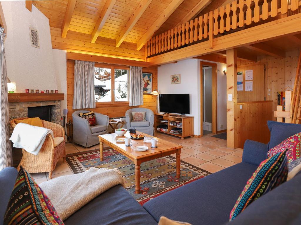 a living room with a couch and a table at Chalet Lara by Interhome in Nendaz