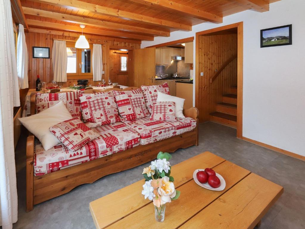 a living room with a couch and a table at Chalet Coucordin by Interhome in Nendaz