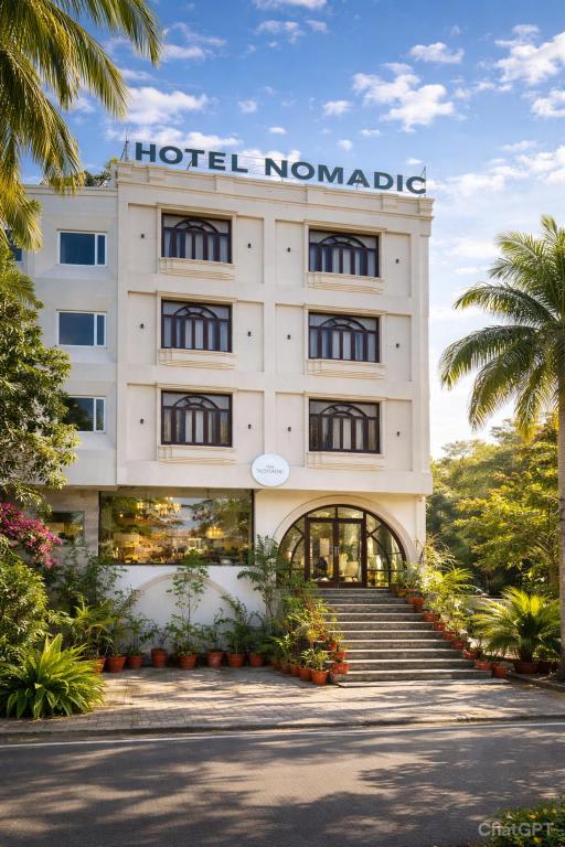 a hotel with a sign on the front of it at Hotel Nomadic in Udaipur