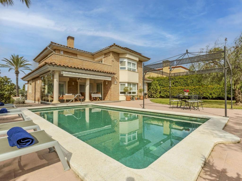 a house with a swimming pool in front of a house at Villa Bertoni Golf & Sea by Interhome in Reus