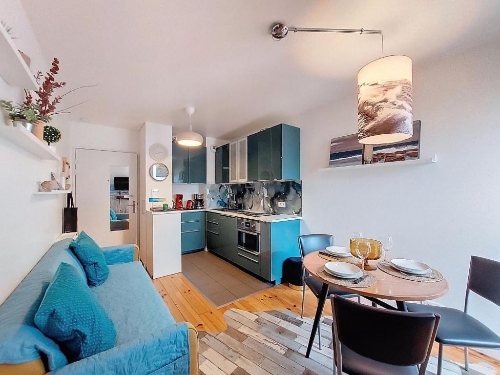a living room with a blue couch and a table at Apartment la Pergola-2 by Interhome in Soorts-Hossegor