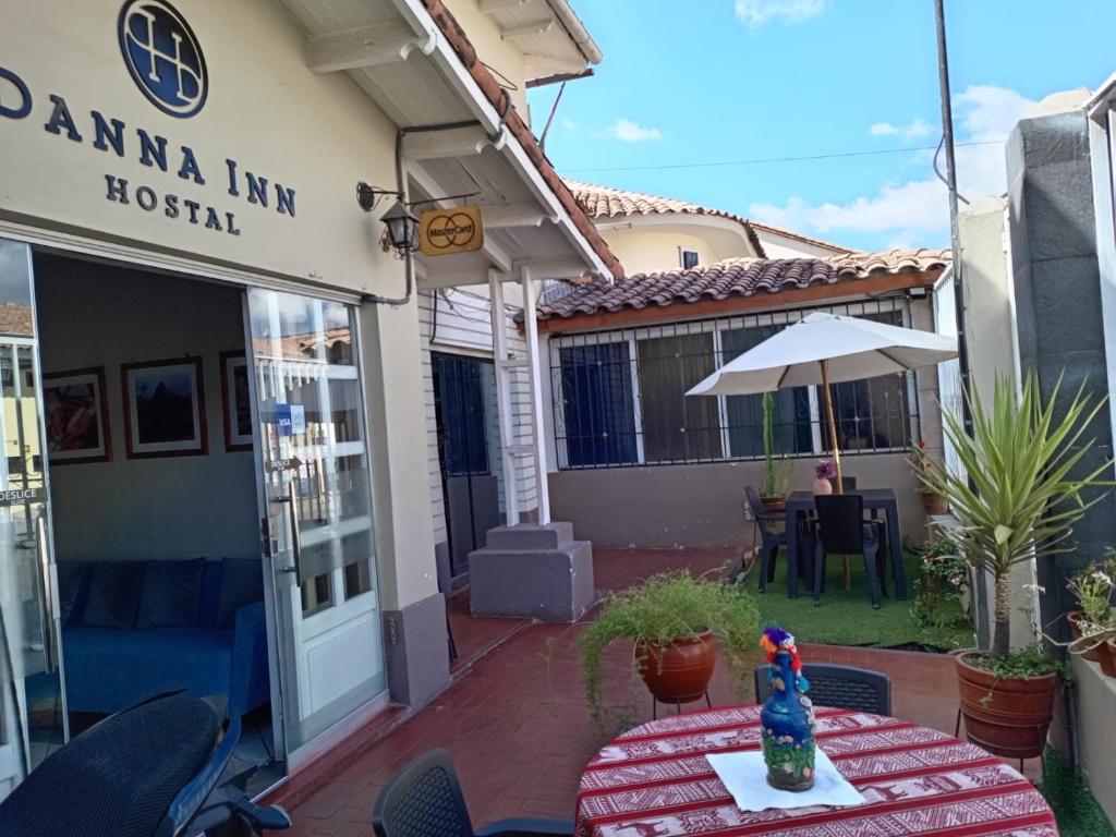 a patio with a table in front of a building at Dannas Inn in San Antonio