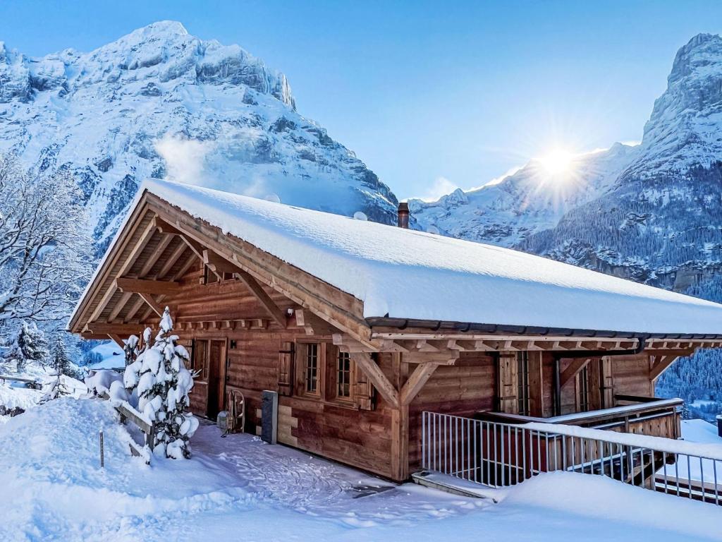 a log cabin in the mountains in the snow at Chalet Chalet Andra by Interhome in Grindelwald