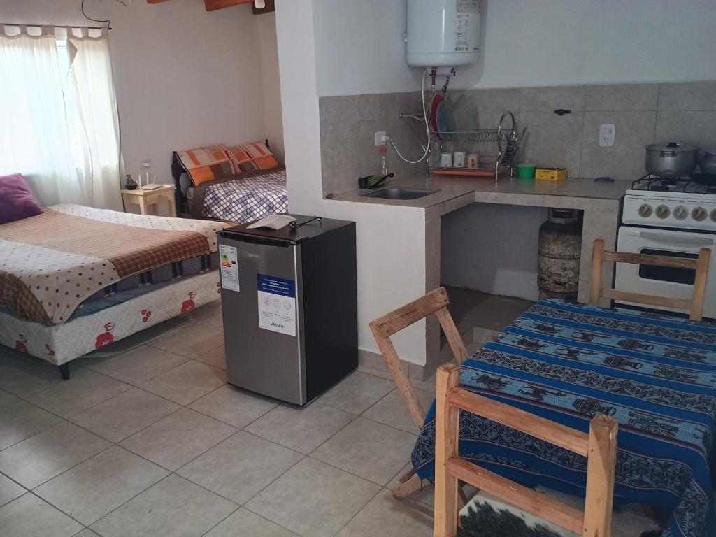 a kitchen with a sink and a refrigerator in a room at Wally wally 2 in Senador Pérez