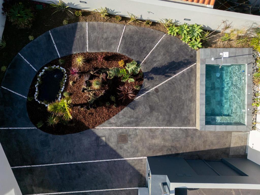 an overhead view of a garden on the side of a house at Essence Villas - Garden & Spa in Ribeira Grande