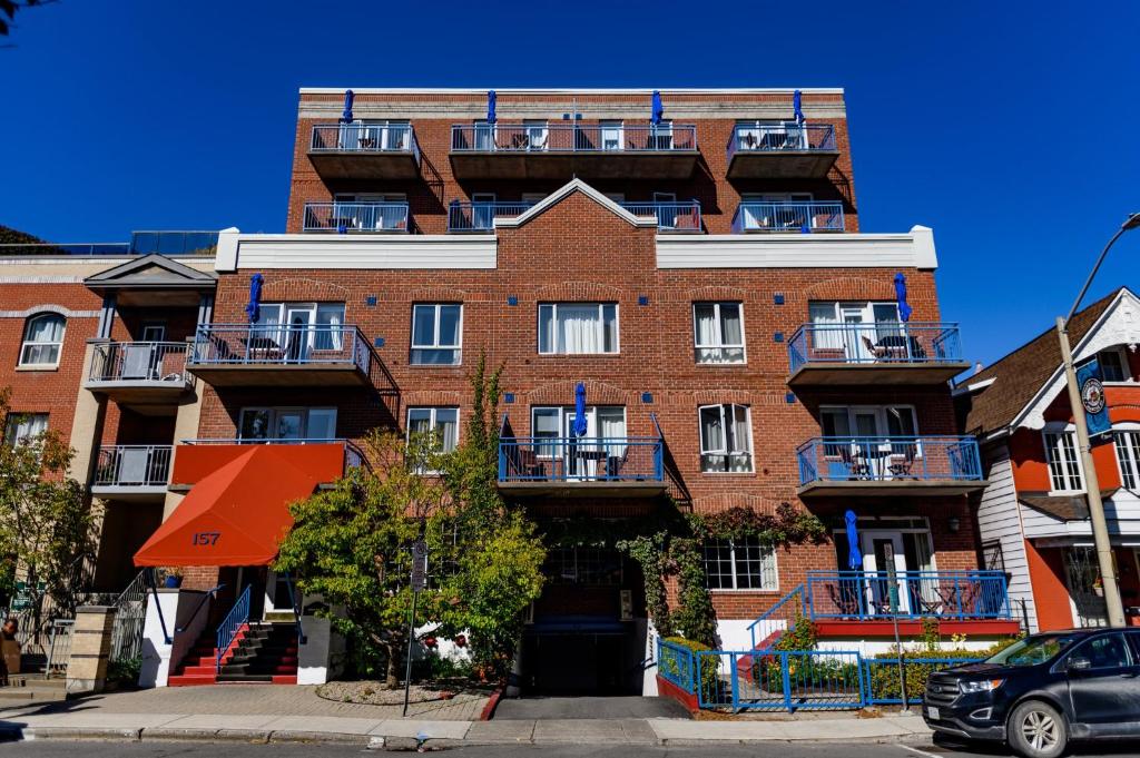 a large brick building with balconies on a street at ByWard Blue Inn in Ottawa