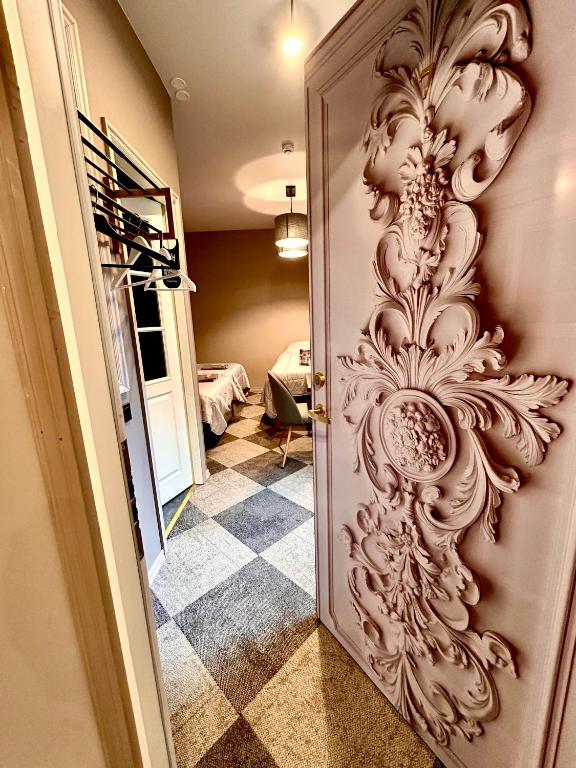 a door with a carving on it in a room at Best apartments Narva in Narva