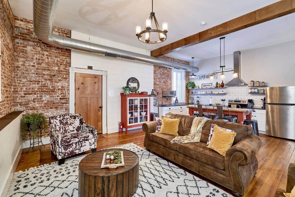 a living room with a couch and a table at Studio 1892 Guesthouse in Hermann