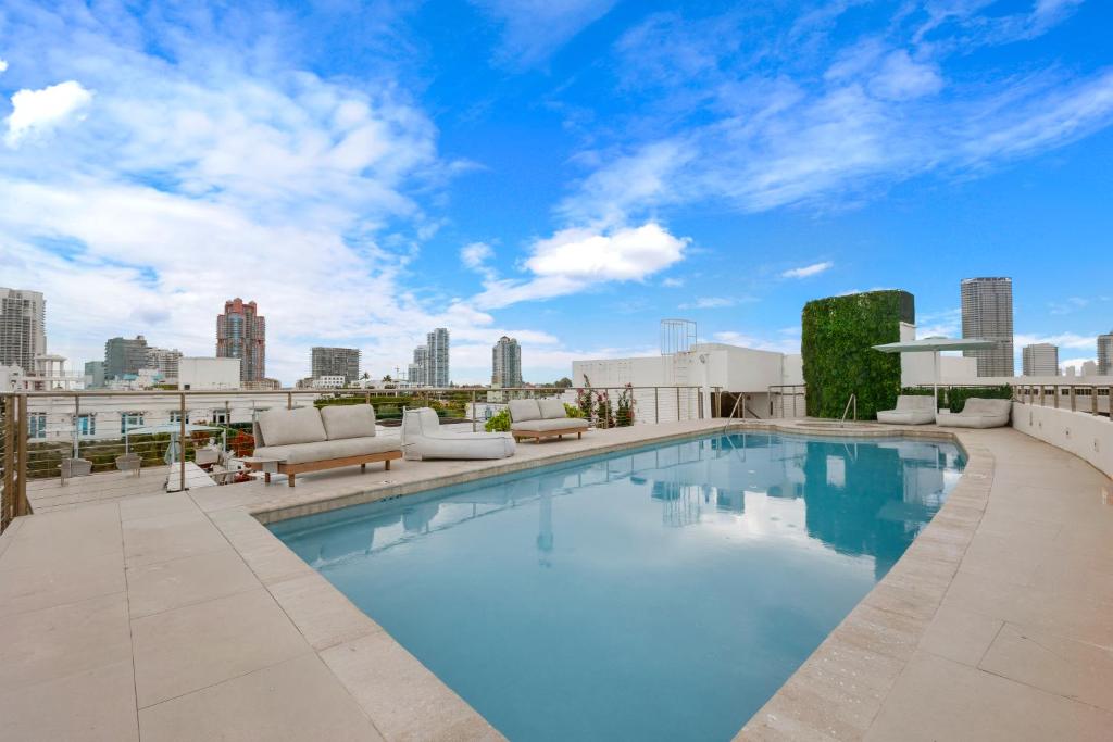 a swimming pool on the roof of a building at Bentley Hotel South Beach in Miami Beach
