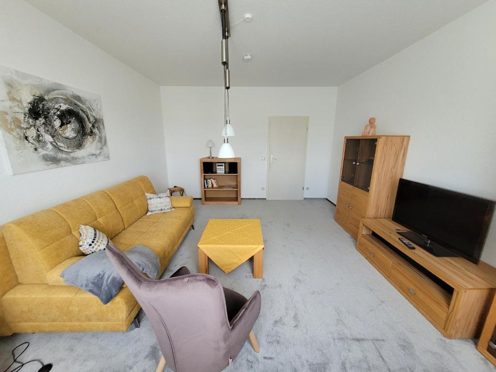 a living room with a couch and a television at Ferienwohnung Bischof in Echzell