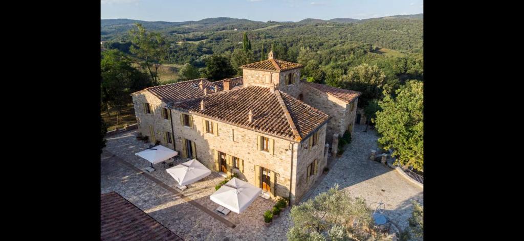 an aerial view of a large stone building with trees at La Pietra Dorata in Rapolano Terme