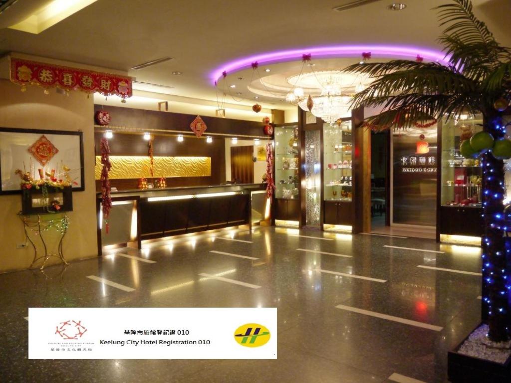 a lobby with a christmas tree in the center of a building at Beidoo Hotel in Keelung