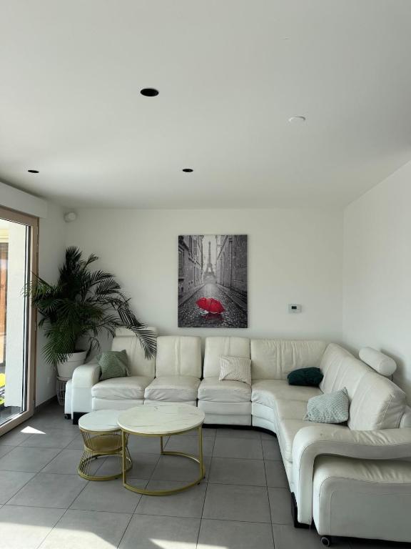a living room with a white couch and a table at DAKEY home - Disneyland Paris, Village Nature in Magny-le-Hongre