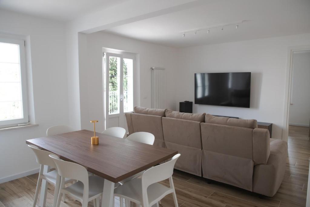 a living room with a couch and a table and chairs at Villa Serena - Luminor Apartment in Tirrenia