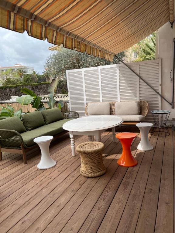 a patio with a table and chairs on a deck at Maison Palamos La Fosca in Palamós