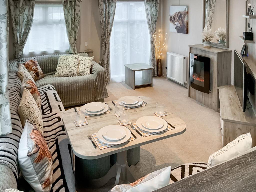a living room with a table and a couch at 54 Beach Retreat in Burnham on Sea