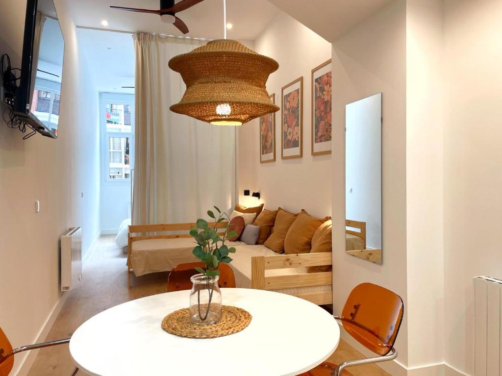 a living room with a table and a couch at Bosko Etxea Apartamentos in Bilbao