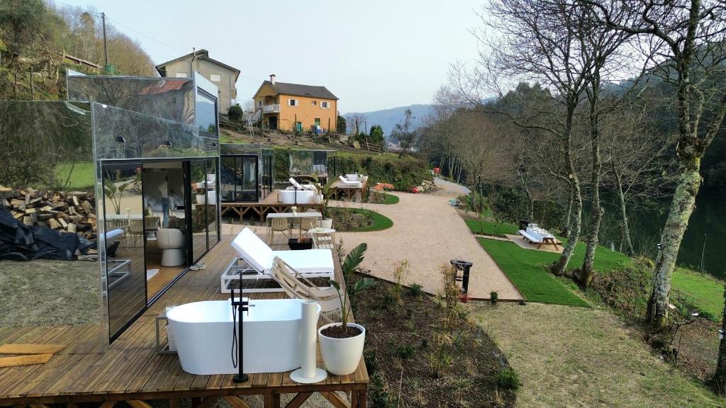 a house with a bath tub on a wooden deck at VILLA La Finca in Vieira do Minho