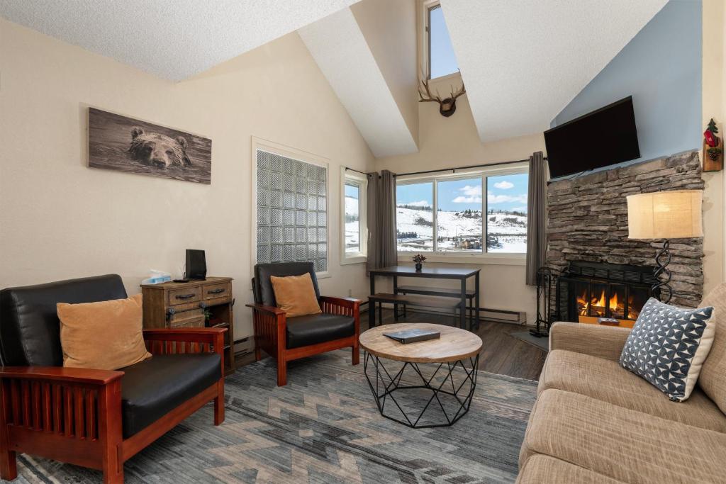 a living room with a couch and a fireplace at Summit Unit 1303 in Granby