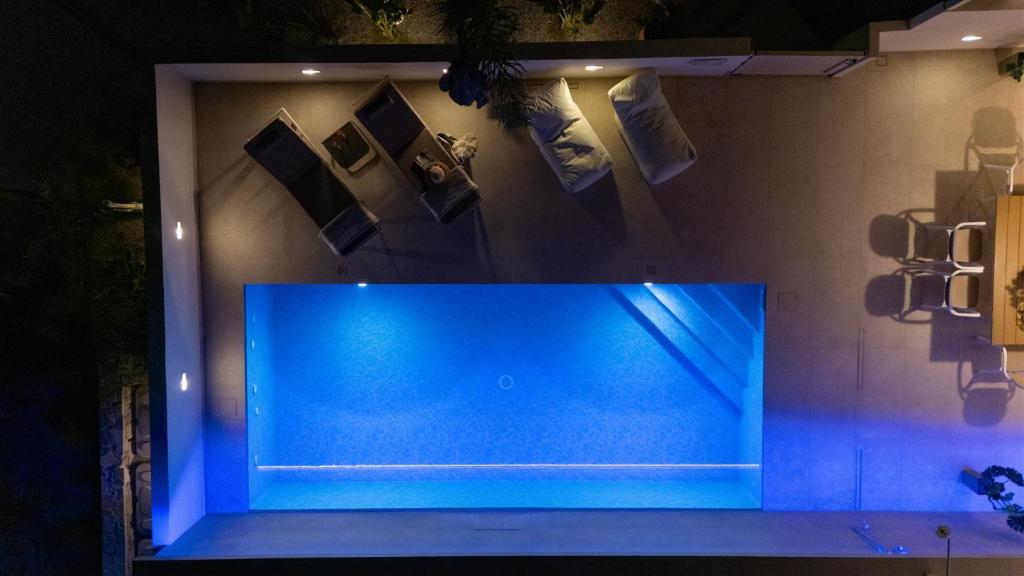 a blue aquarium in a room with a wall at Nerida Luxury Villas in Kastéllion