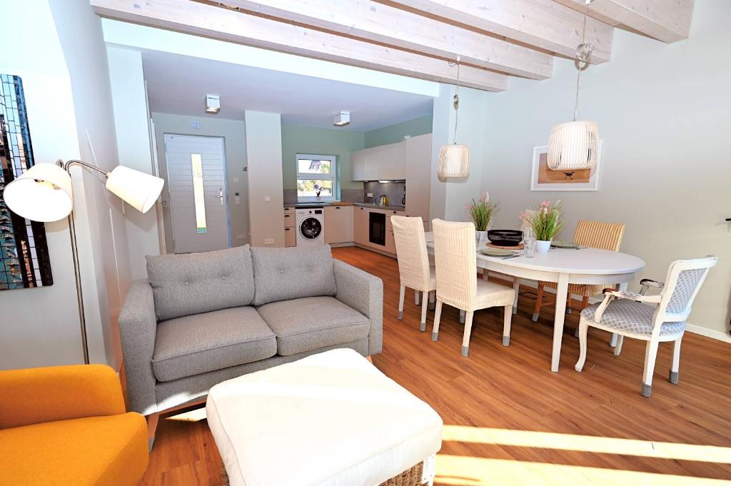 a living room with a couch and a table at Residenz R1 App 3 in Behrensdorf