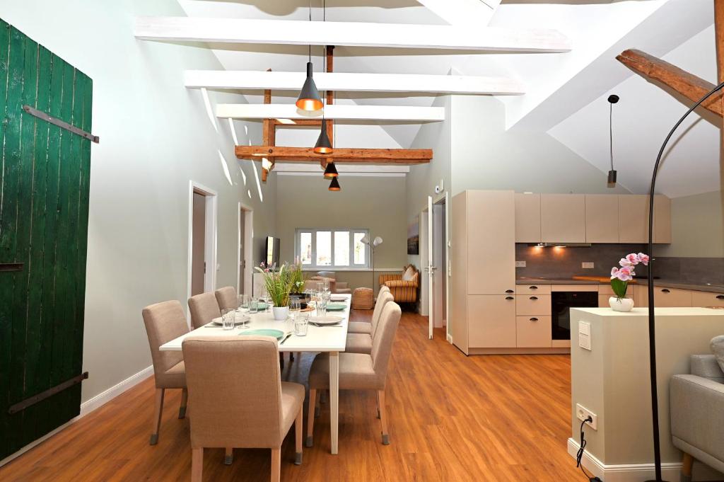 a dining room and living room with a table and chairs at Residenz R1 App 4 in Behrensdorf