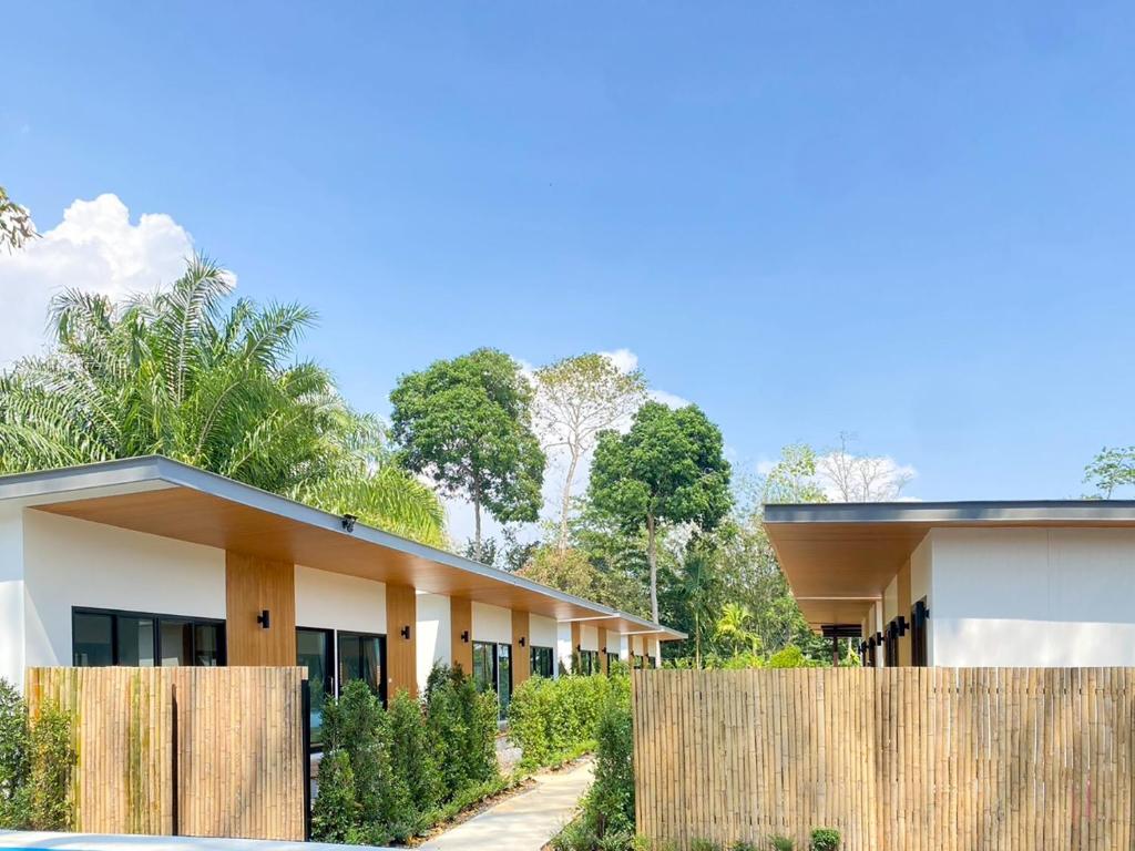 a building with a wooden fence in front of it at Aonang Green Tree in Ao Nang 