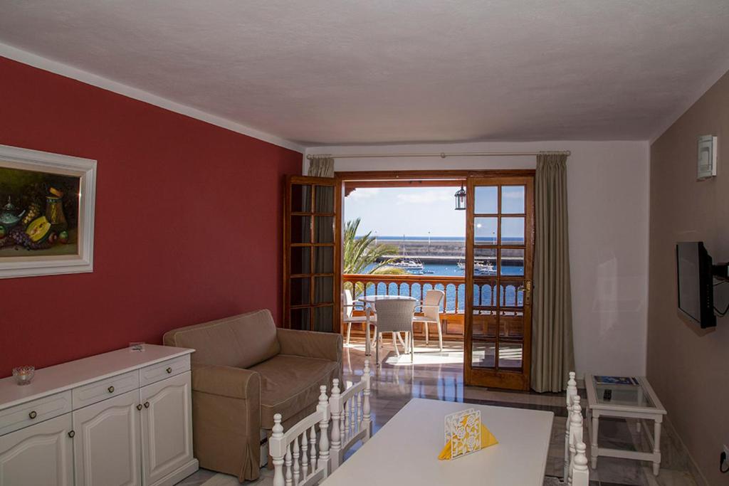 a living room with a couch and a table at Apartamentos Tapahuga in Playa de Santiago