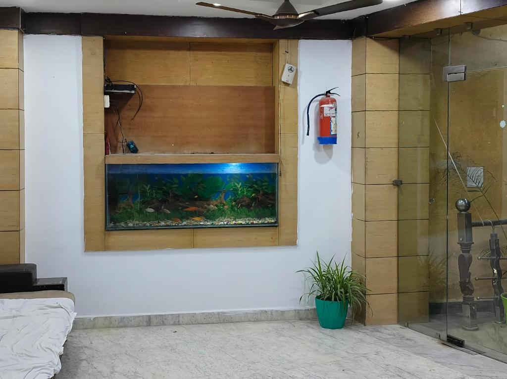 a bathroom with a fish tank in a window at Hotel BR international in Tājganj