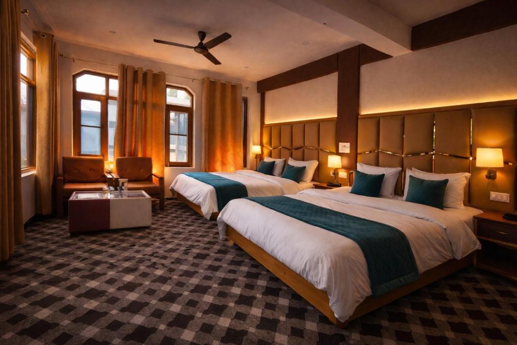 a hotel room with two beds and a ceiling at Gulmarg Gul Sitara Resorts in Gulmarg