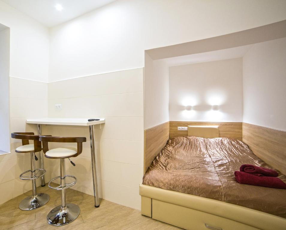 リヴィウにあるMini Smart apartments on Viacheslava Chornovola Avenue 21-1の小さなベッドルーム(ベッド1台、テーブル付)