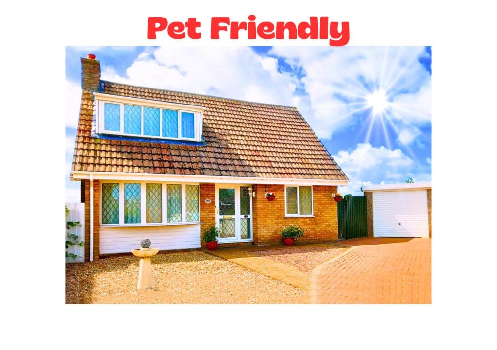 a red brick house with a sign that reads pet friendly at Stunning Holiday Cottage nr Skegness in Sunny Chapel St Leonards Just mins from the Beach & Attractions - Perfect for Couples & Family's who love to Relax but want Exciting Adventures nearby! Large Pet Friendly garden! in Chapel Saint Leonards