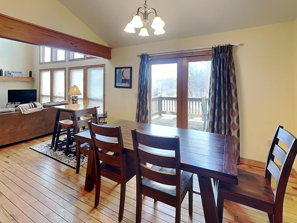 a dining room with a wooden table and chairs at Mountain Top Lodge in McHenry