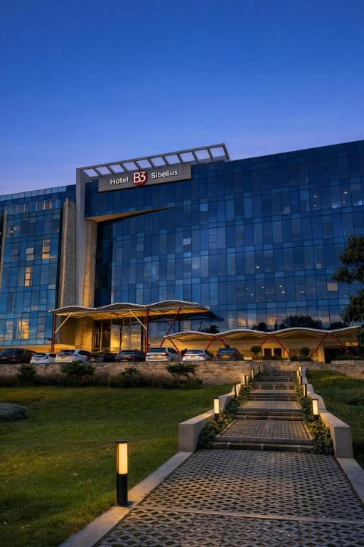 a large building with a walkway in front of it at Hotel B3 Sibelius in Chía