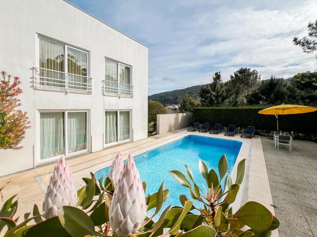 a swimming pool in the backyard of a house at Casa das Rampas - Nature Retreat with Pool in Moledo
