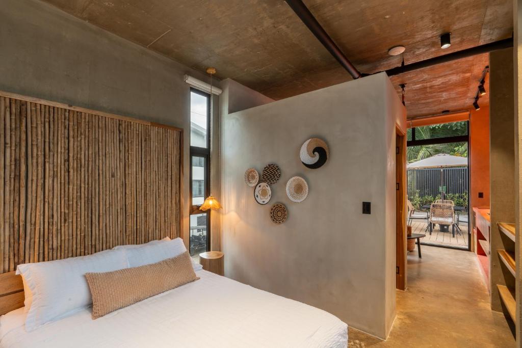 a bedroom with a white bed and a large window at The Terrace Retreat in Jacó