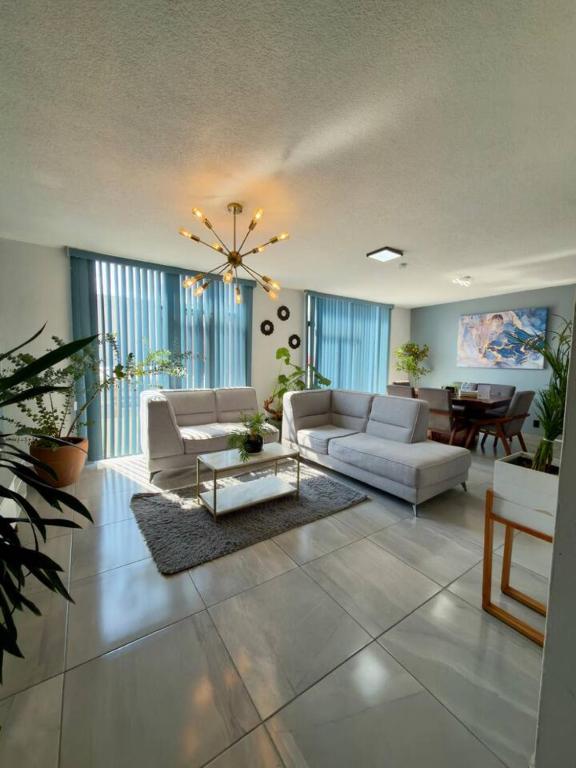 a living room with two couches and a table at AR Suites 3 La Calzada in Zamora de Hidalgo
