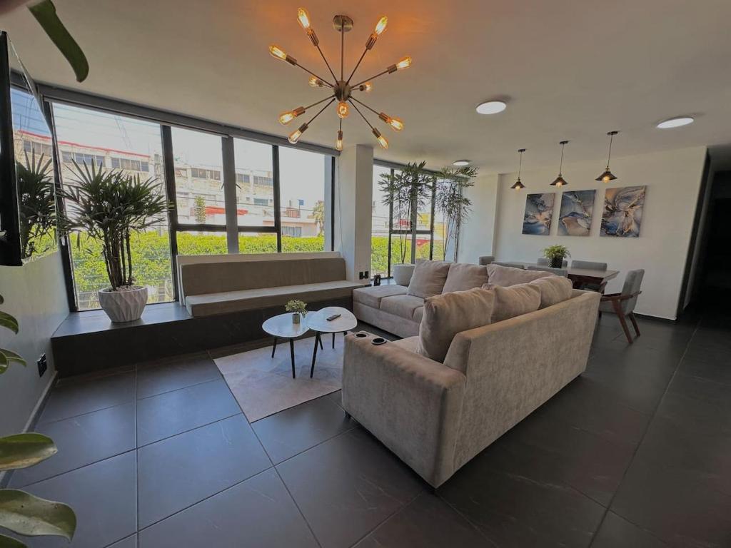 a living room with a couch and a table at AR Suites 2 La Calzada in Zamora de Hidalgo